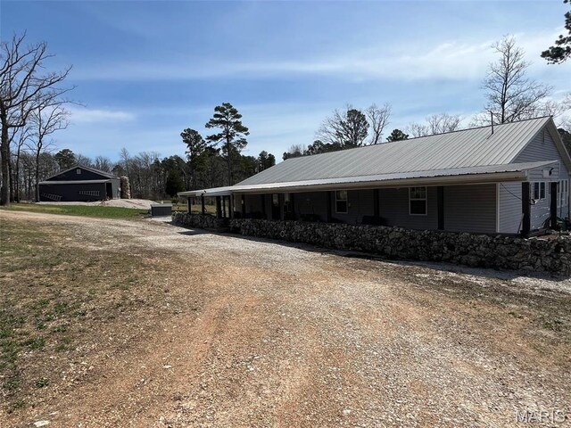 10303 Woodberry Rd, Potosi, MO 63664 - view of side of home featuring driveway, a porch, and metal roof
