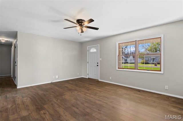 1112 N Illinois Ave, Litchfield, IL 62056 - unfurnished living room featuring a ceiling fan, dark wood-style flooring, and baseboards