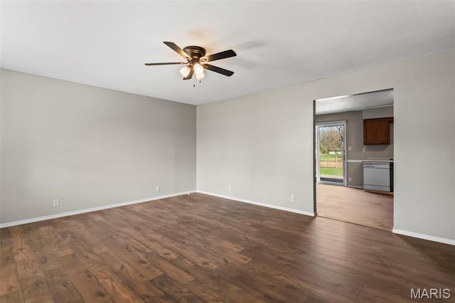 1112 N Illinois Ave, Litchfield, IL 62056 - spare room with a ceiling fan, dark wood-type flooring, and baseboards
