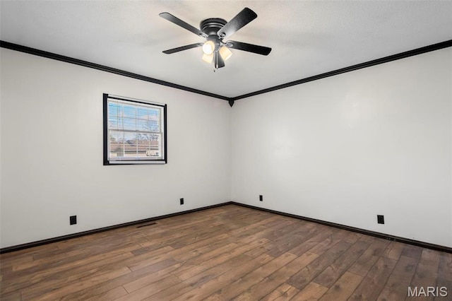 1112 N Illinois Ave, Litchfield, IL 62056 - empty room featuring crown molding, wood finished floors, ceiling fan, and baseboards