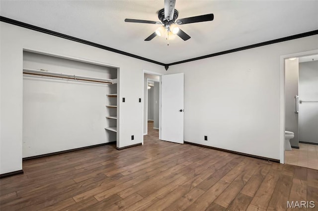 1112 N Illinois Ave, Litchfield, IL 62056 - unfurnished bedroom featuring crown molding, wood finished floors, a closet, connected bathroom, and baseboards