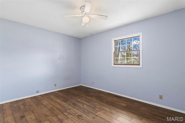 1112 N Illinois Ave, Litchfield, IL 62056 - empty room featuring wood-type flooring, ceiling fan, and baseboards