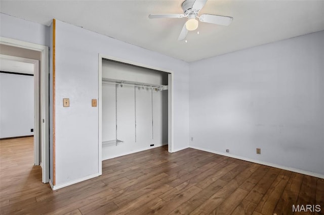 1112 N Illinois Ave, Litchfield, IL 62056 - unfurnished bedroom featuring wood finished floors, a closet, baseboards, and a ceiling fan