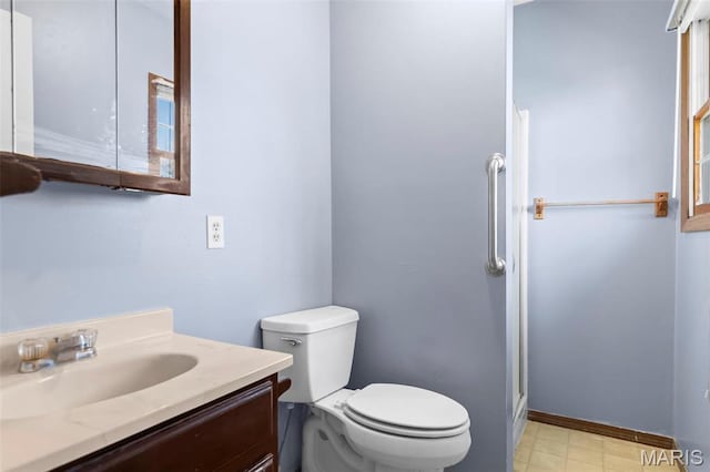 1112 N Illinois Ave, Litchfield, IL 62056 - bathroom featuring a stall shower, vanity, and toilet