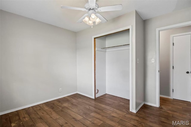 1112 N Illinois Ave, Litchfield, IL 62056 - unfurnished bedroom featuring wood finished floors, baseboards, a closet, and a ceiling fan