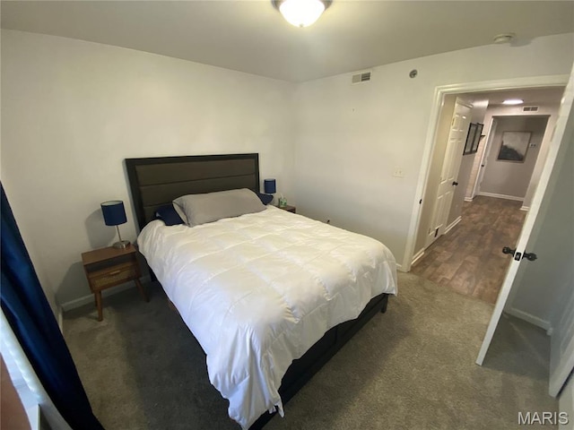 carpeted bedroom featuring baseboards