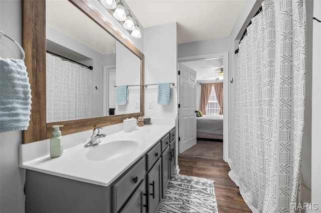 full bathroom with vanity, a ceiling fan, wood finished floors, and ensuite bathroom