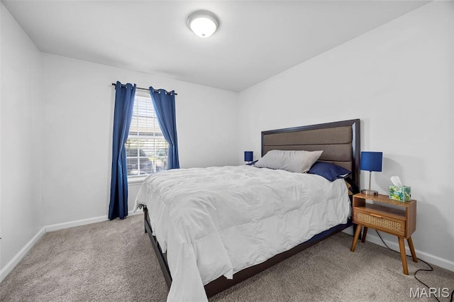 bedroom with carpet floors and baseboards
