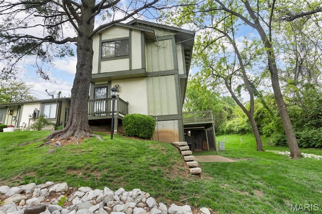 11148 Whispering Oaks Dr, Saint Louis, MO 63136 - rear view of house with a wooden deck and a lawn