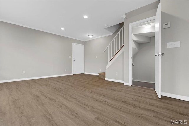 11148 Whispering Oaks Dr, Saint Louis, MO 63136 - unfurnished living room featuring ornamental molding, baseboards, stairway, wood finished floors, and recessed lighting