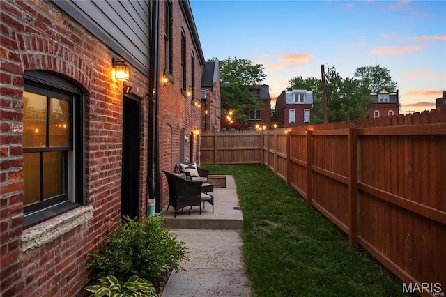 yard at dusk with a patio
