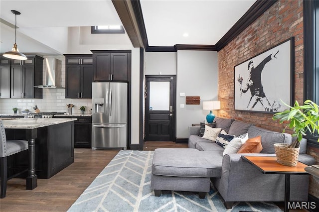 living area with ornamental molding and dark wood-type flooring