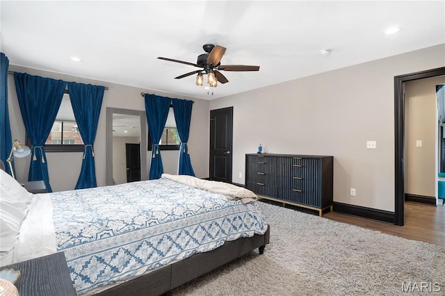 bedroom with wood finished floors, baseboards, recessed lighting, and ceiling fan