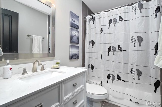 full bath featuring toilet, vanity, and curtained shower