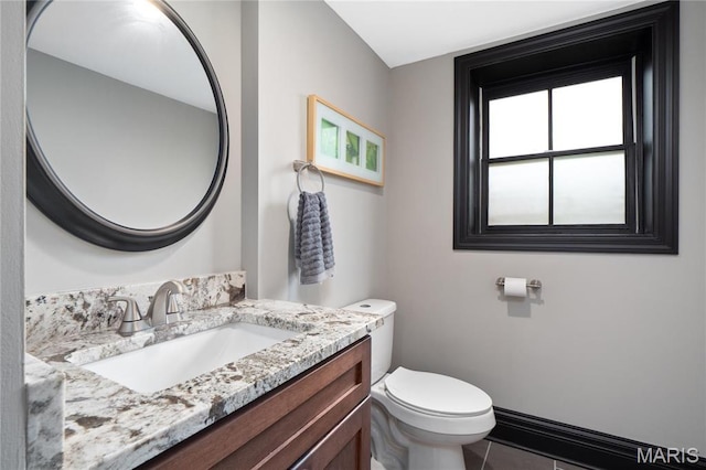bathroom featuring toilet, vanity, and tile patterned floors