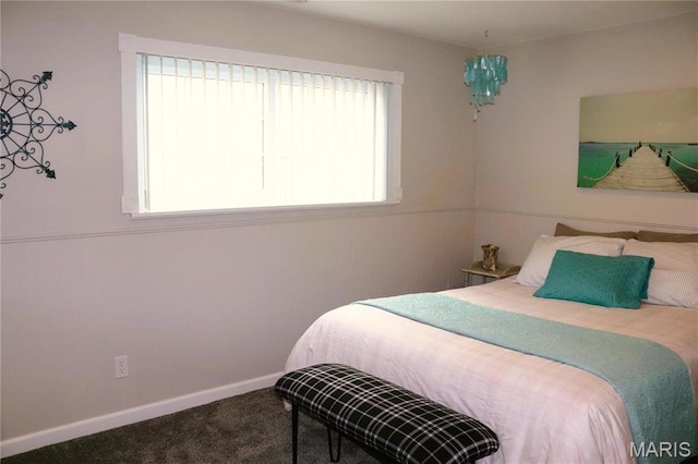 bedroom featuring carpet floors and baseboards