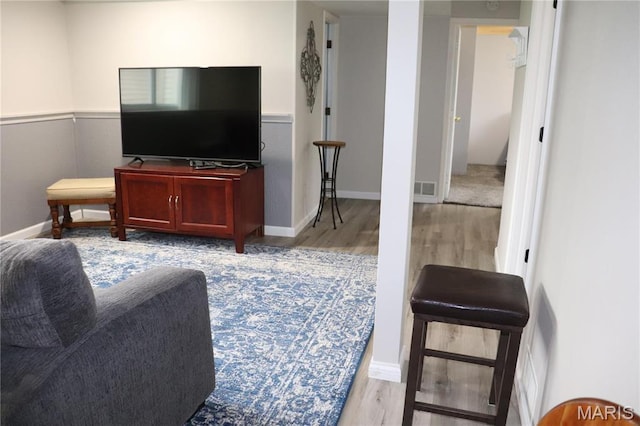 living area featuring wood finished floors and baseboards