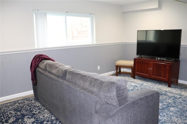 living area featuring baseboards