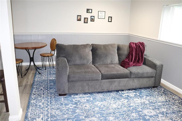 living room with wood finished floors and baseboards