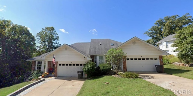 view of front of property featuring an attached garage, concrete driveway, brick siding, and a front yard