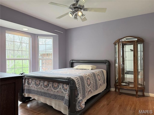bedroom with wood finished floors, baseboards, and a ceiling fan