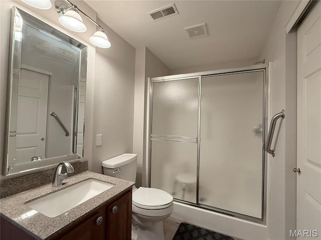 full bathroom featuring toilet, a shower stall, vanity, and tile patterned floors