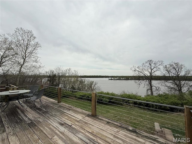 deck featuring a water view and outdoor dining space