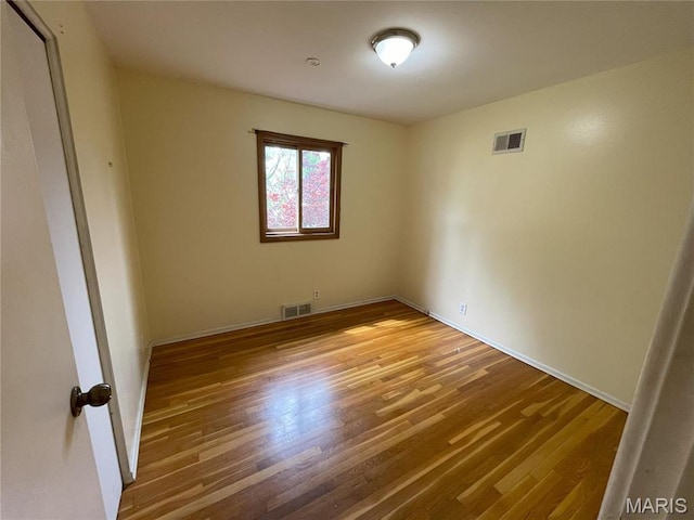 unfurnished room featuring wood finished floors and baseboards
