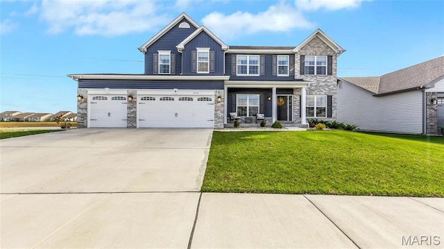 view of front of house featuring concrete driveway, stone siding, board and batten siding, a front yard, and covered porch