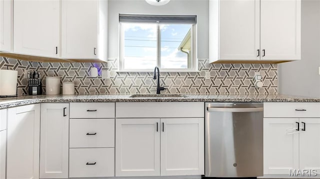 kitchen with dishwasher, a sink, white cabinetry, and decorative backsplash