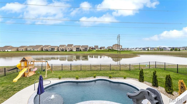 view of pool with a water slide, a playground, a residential view, and a water view