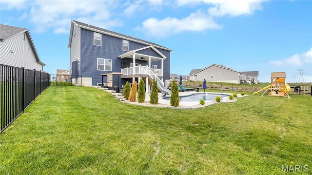 back of property with stairs, a playground, and a deck