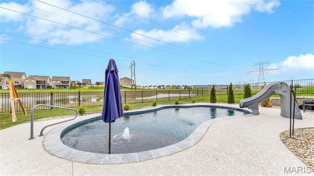 view of swimming pool with a water slide and a fenced backyard