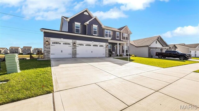 view of front facade with concrete driveway, stone siding, a front lawn, and a garage