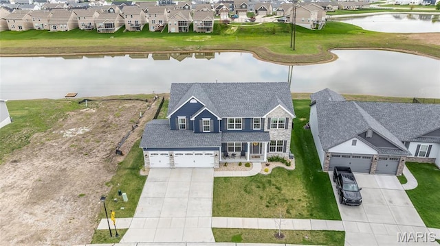 aerial view of residential area featuring a nearby body of water