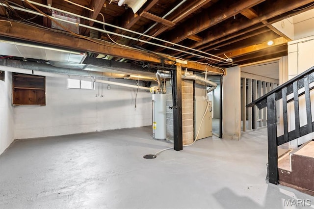 below grade area featuring water heater and stairs