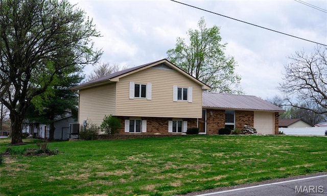 split level home featuring brick siding and a garage