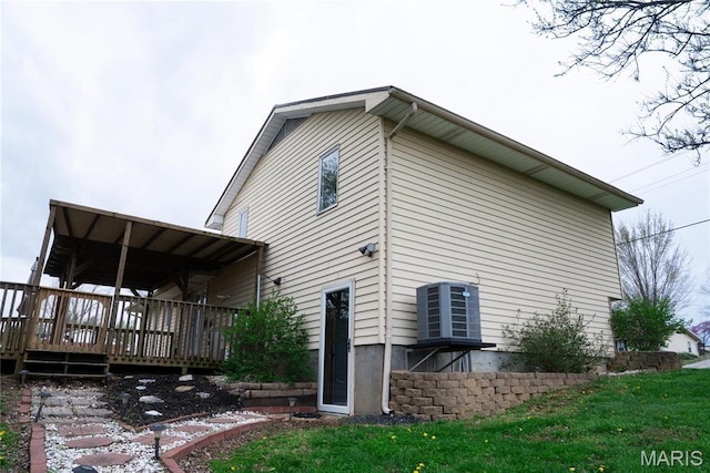 view of property exterior featuring a wooden deck and central AC unit