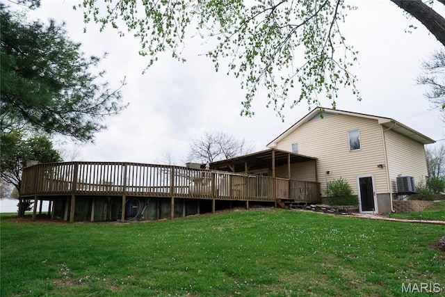 rear view of house with a deck, a yard, and central AC unit