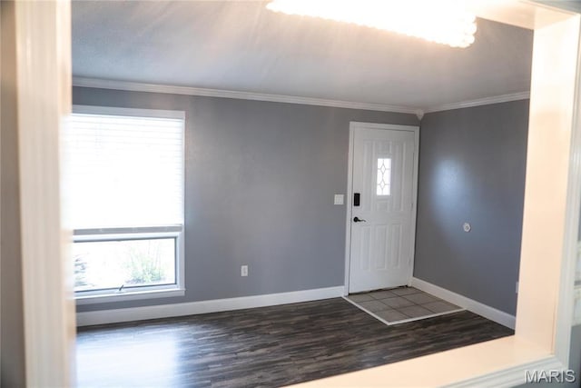 foyer entrance with wood finished floors, baseboards, and ornamental molding