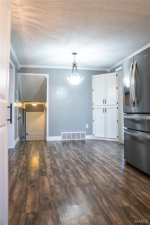 unfurnished living room featuring ornamental molding, dark wood-type flooring, and baseboards