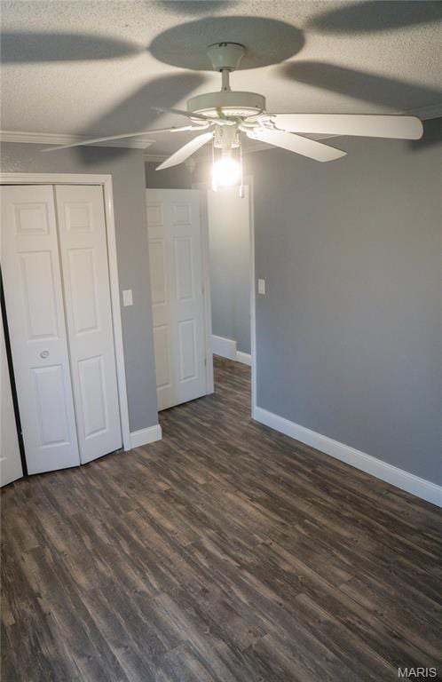 unfurnished bedroom featuring a textured ceiling, baseboards, a closet, ceiling fan, and dark wood-style flooring