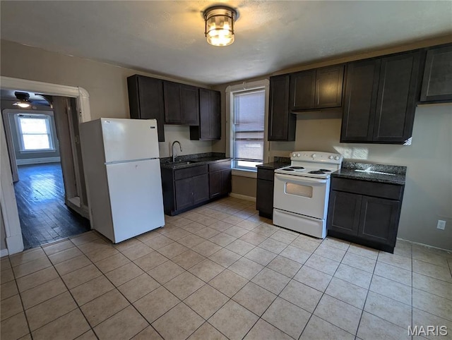4610 Pope Ave, Saint Louis, MO 63115 - kitchen with white appliances, a sink, and light tile patterned flooring