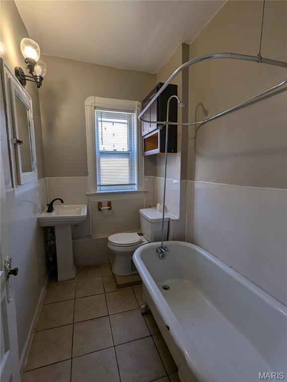 4610 Pope Ave, Saint Louis, MO 63115 - bathroom with toilet, tile patterned flooring, and a bath