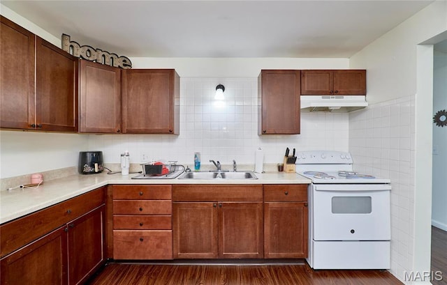 595 Cap Au Gris St, Troy, MO 63379 - kitchen featuring white range with electric stovetop, under cabinet range hood, a sink, dark wood-type flooring, and light countertops