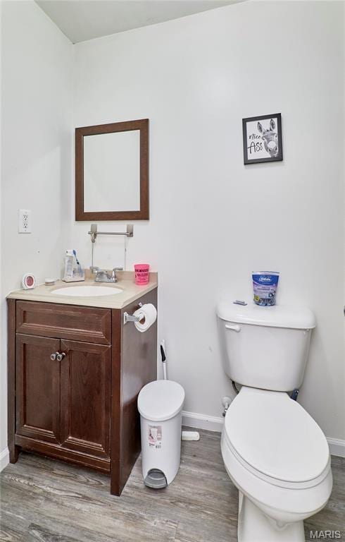 595 Cap Au Gris St, Troy, MO 63379 - half bath featuring baseboards, wood finished floors, and toilet