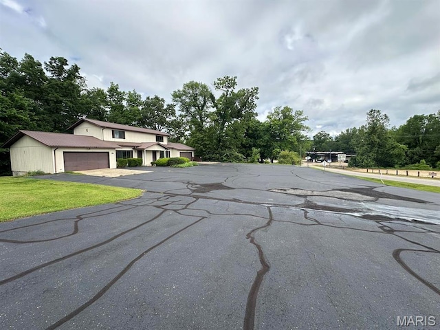 view of asphalt road with view of scattered trees