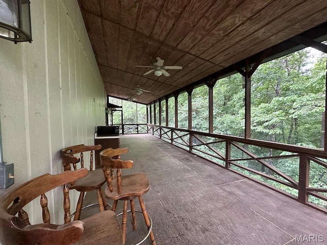 sunroom / solarium featuring ceiling fan