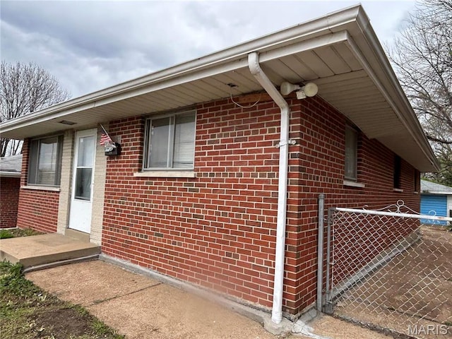 3757 Itaska St, Saint Louis, MO 63116 - view of side of home featuring brick siding and fence