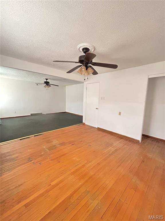 3757 Itaska St, Saint Louis, MO 63116 - empty room featuring a textured ceiling, ceiling fan, light wood-style flooring, and baseboards